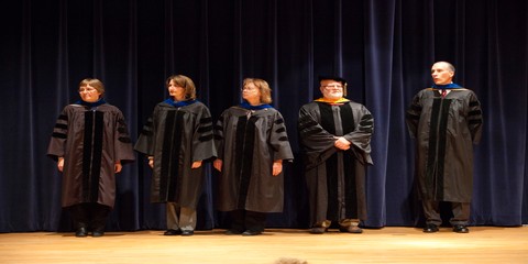 Faculty members wait their turn on stage during convocation